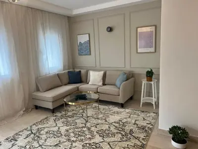 a living room with a couch and a table at Appartement 2 chambres in Casablanca