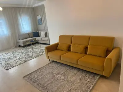 a living room with a brown couch in a living room at Appartement 2 chambres in Casablanca
