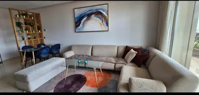 a living room with a couch and a glass table at Appartement Chic CFC - Anfasky in Casablanca