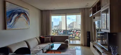a living room with a couch and a large window at Appartement Chic CFC - Anfasky in Casablanca