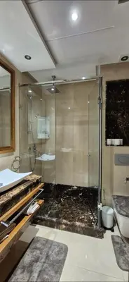 a bathroom with a glass shower and a sink at Appartement Chic CFC - Anfasky in Casablanca