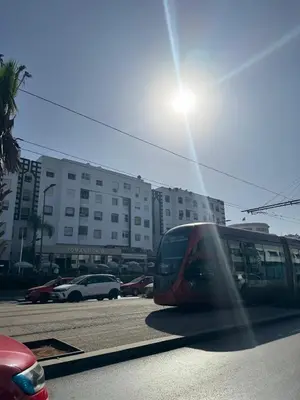 a train is parked in a parking lot at Opposite Train Station & Tram Modern Quiet & Meals Available in Casablanca