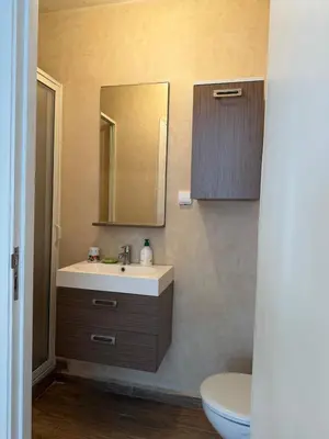 a bathroom with a sink and a mirror and a toilet at Villa front mer in Rabat