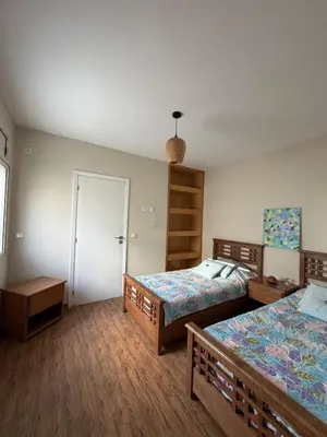 a bedroom with two beds and a closet at Villa front mer in Rabat