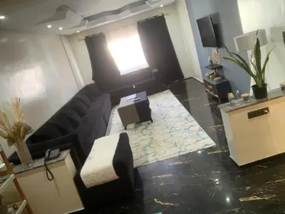 a living room with a couch and a window at Appartement 5 pieces à casablanca in Casablanca