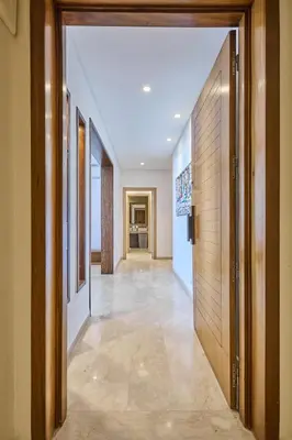 a hallway with wooden doors and tile flooring at Sunny Spacious 3 BR Apartment CIL view in Casablanca