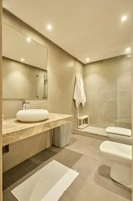 a bathroom with a sink and a toilet and a mirror at Sunny Spacious 3 BR Apartment CIL view in Casablanca