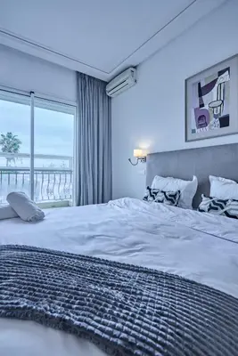 a bedroom with a large bed with a view of the ocean at Sunny Spacious 3 BR Apartment CIL view in Casablanca