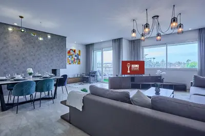 a living room with a couch and a dining room at Sunny Spacious 3 BR Apartment CIL view in Casablanca