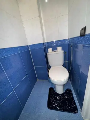 a blue and white bathroom with a toilet in it at Comfortable apartment, Stade in Rabat