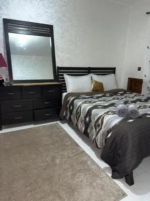 a bedroom with a bed with a large mirror at Comfortable apartment, Stade in Rabat