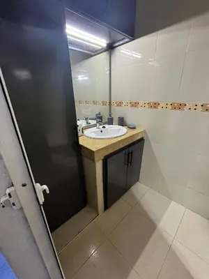 a bathroom with a sink and a mirror at Comfortable apartment, Stade in Rabat