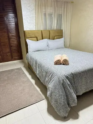 a bedroom with a bed with two towels on it at Comfortable apartment, Stade in Rabat