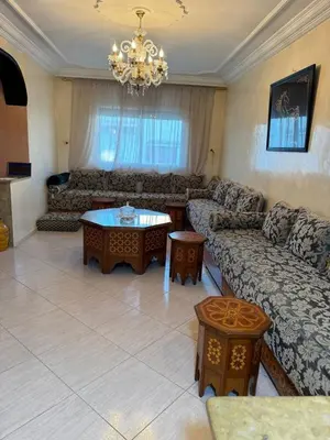 a living room with a couch and a table at Comfortable apartment, Stade in Rabat