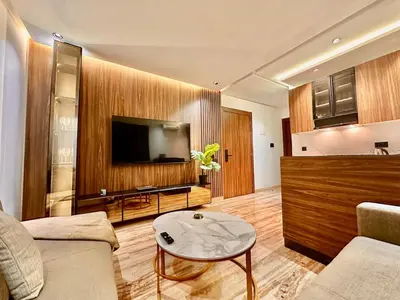 a living room with a couch and a tv at Cozy & Central with Terrace, Parking and Fiber Wifi in Casablanca