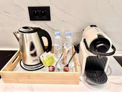 a tea kettle and water bottles on a counter at Cozy & Central with Terrace, Parking and Fiber Wifi in Casablanca