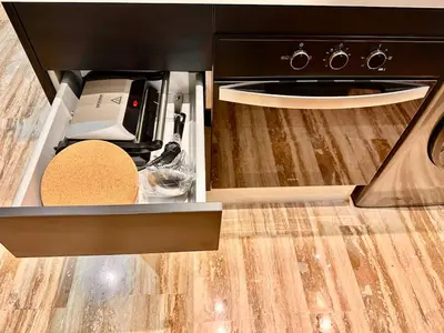 an open drawer of a kitchen with a stove at Cozy & Central with Terrace, Parking and Fiber Wifi in Casablanca