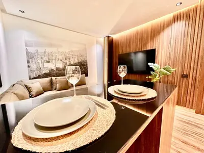 a living room with two plates and wine glasses at Cozy & Central with Terrace, Parking and Fiber Wifi in Casablanca