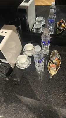 a counter with plates and bottles of water on it at Apartment in Maarif in Maarif