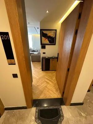 a hallway leading into a living room with a door at Apartment in Maarif in Maarif