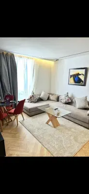 a living room with a couch and a glass table at Apartment in Maarif in Maarif