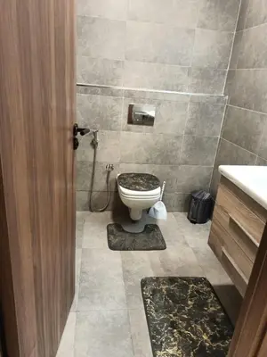 a bathroom with a toilet and a sink at Appartement haut standing piscine et fitness in Mohammedia