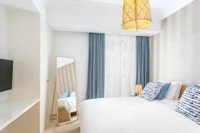 a bedroom with a white bed and a mirror at CFC, cozy 2 bedrooms apartment living room in Casablanca