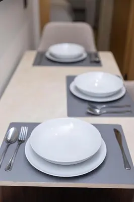 two white plates and utensils on a table at Premium Studio H&M - Near CFC and Anfa Park in Casablanca