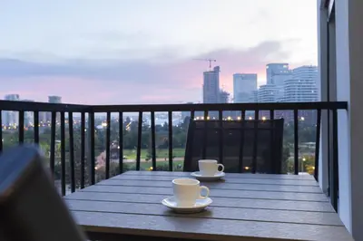 two coffee cups sitting on a wooden table on a balcony at Premium Studio H&M - Near CFC and Anfa Park in Casablanca