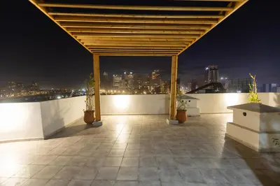 a rooftop patio with a view of the city at night at Premium Studio H&M - Near CFC and Anfa Park in Casablanca