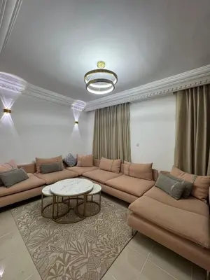 a living room with a couch and a table at Opposite Train Station & Tram Modern, Quiet & Meals Available in Casablanca