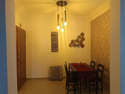 a dining room with a table and chairs and a chandelier at Opposite Train Station & Tram Modern, Quiet & Meals Available in Casablanca