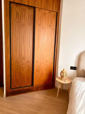 a wooden door in a bedroom with a table at Quiet, Sunny Studio 3 min CFC - Self-Check-In in Casablanca