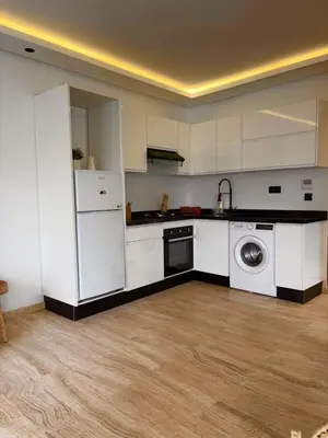 a kitchen with white cabinets and a washing machine at Quiet, Sunny Studio 3 min CFC - Self-Check-In in Casablanca