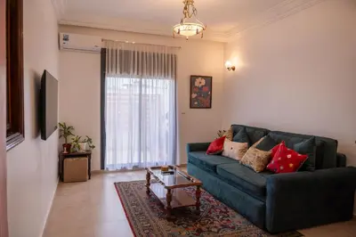 a living room with a couch and a table at Downtown Casablanca Living Terrace & Tram Access in Casablanca