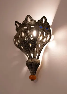 a black lamp hanging on a wall at Downtown Casablanca Living Terrace & Tram Access in Casablanca