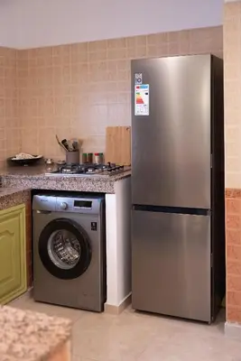 a kitchen with a refrigerator and a washing machine at Downtown Casablanca Living Terrace & Tram Access in Casablanca