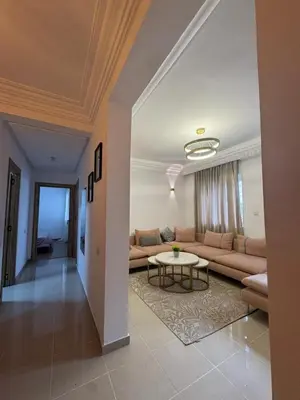 a living room with a couch and a table at Face à la Gare et au Tramway Moderne, Calme avec Resto sur place possible in Casablanca