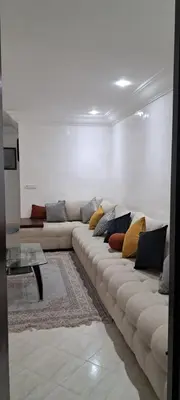 a living room with a couch and a table at Appartement près de la corniche in Casablanca