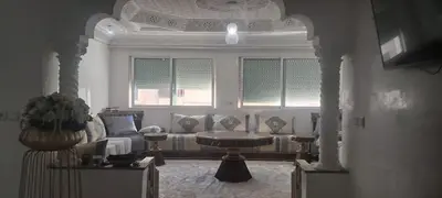 a living room with a couch and a table at Appartement près de la corniche in Casablanca