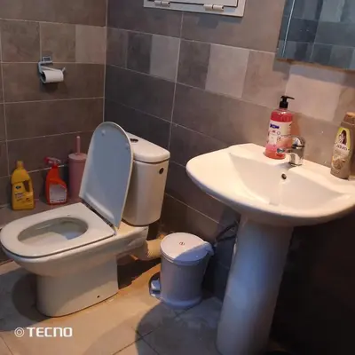 a bathroom with a toilet and a sink at Hébergement de lux près stades in Rabat