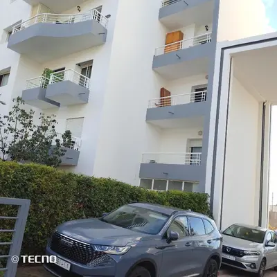a car parked in front of a building at Hébergement de lux près stades in Rabat