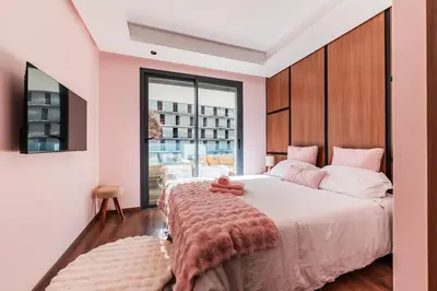 a bedroom with a bed with a teddy bear on it at Uptown Casa Anfa Luxury at Casa Finance City in Casablanca