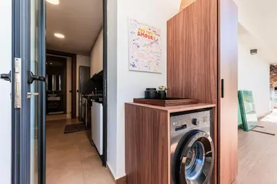 a laundry room with a washer and dryer at Uptown Casa Anfa Luxury at Casa Finance City in Casablanca