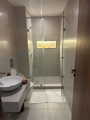 a bathroom with a shower with a toilet and a sink at Studio Zen in Maarif