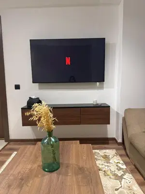 a living room with a tv and a vase on a table at Studio Zen in Maarif