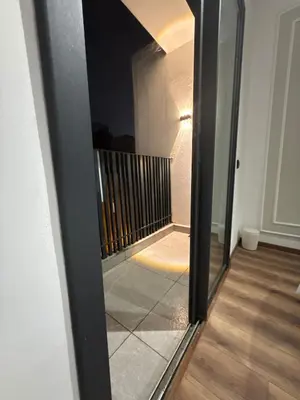 a mirror reflection of a hallway in a house at Studio Zen in Maarif