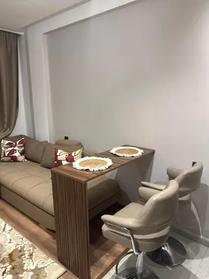 a living room with a couch and a table and chairs at Studio Zen in Maarif