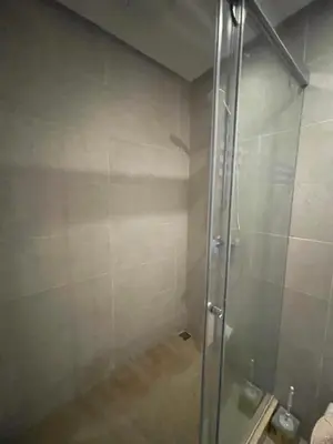 a shower with a glass door in a bathroom at appartement 5min a pied du stade in Rabat