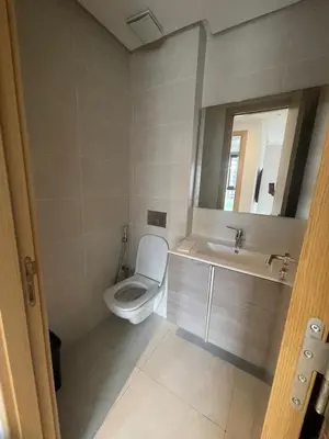 a bathroom with a toilet and a sink and a mirror at appartement 5min a pied du stade in Rabat
